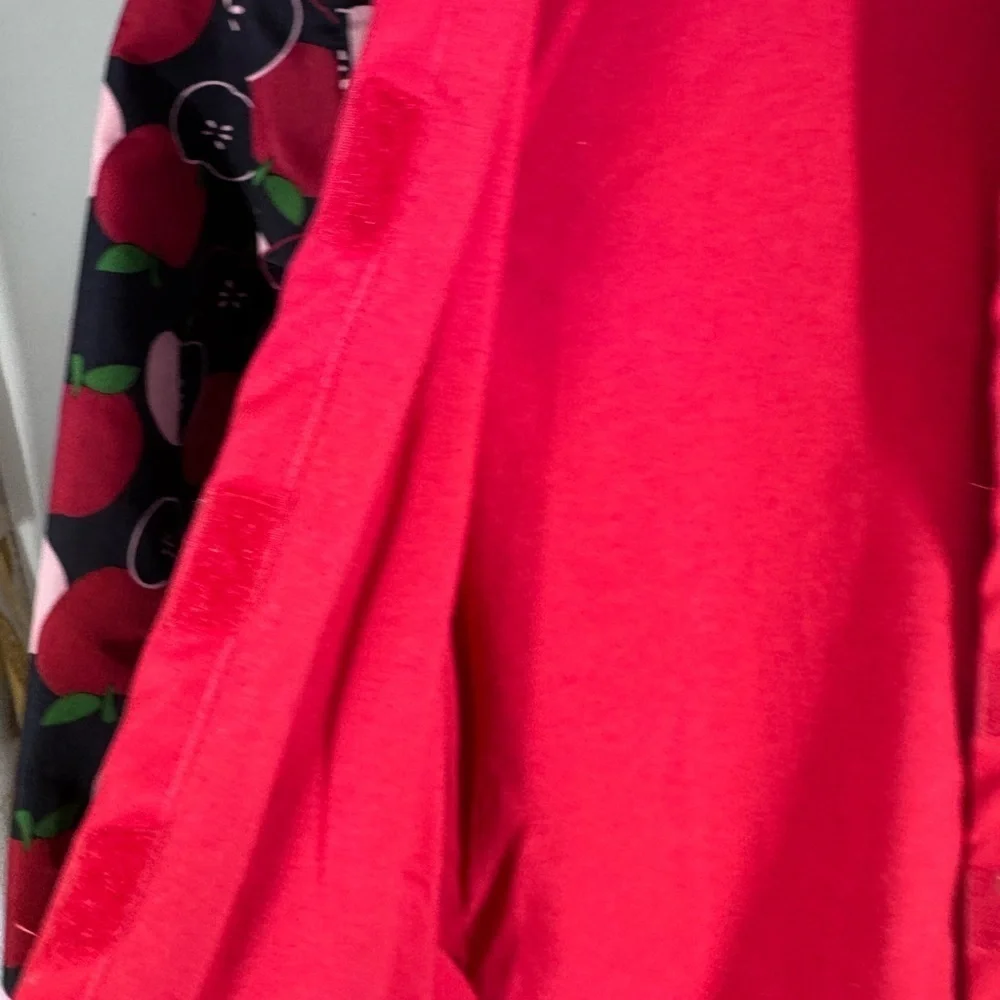Gymboree lined raincoat with accessible zelcro closures. Apple print 7-8 Y